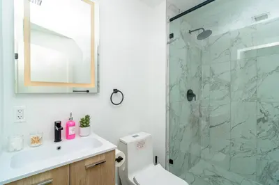a bathroom with a shower and a toilet and a sink at Miami 1BR New Oasis with King Bed Near Brickell & Marlins Park in Miami