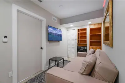 a living room with a couch and a flat screen tv at Anselmo Brickell Apartments in Miami