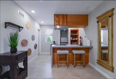 a kitchen with a counter and stools in a room at Anselmo Brickell Apartments in Miami