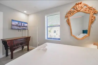 a bedroom with a desk and a mirror at Anselmo Brickell Apartments in Miami