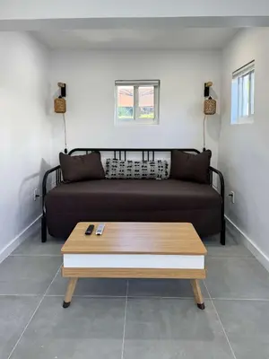 a living room with a couch and a coffee table at Quiet Shenandoah Retreat, Central Miami in Miami