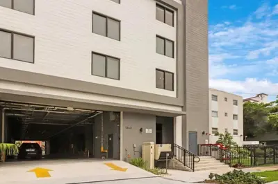 a building with a garage with a car in it at Luxury Studio Suite with King Bed Near Brickell & Marlins Park in Miami