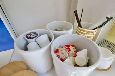 two white buckets filled with eggs and chopsticks on a counter at Ocean Drive Suite in South Beach Family & Pet Friendly in Miami Beach