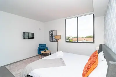 a white bedroom with a bed and a window at Prime Miami Retreat with King Bed Near Brickell & Marlins Park in Miami