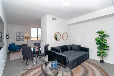 a living room with a couch and a table at Prime Miami Retreat with King Bed Near Brickell & Marlins Park in Miami