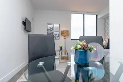 a living room with a glass table and chairs at Prime Miami Retreat with King Bed Near Brickell & Marlins Park in Miami