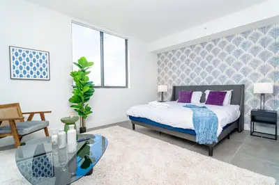 a bedroom with a bed and a glass table at Stylish Studio Miami Suite Oasis Near Calle Ocho & Brickell in Miami