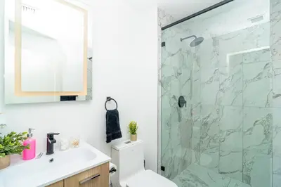 a bathroom with a shower with a toilet and a sink at Stylish Studio Miami Suite Oasis Near Calle Ocho & Brickell in Miami