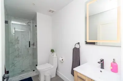 a bathroom with a shower and a toilet and a sink at Miami City Escape 2BR Suite Near Brickell & The Beach Sleeps 6 Guests in Miami