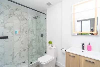 a bathroom with a shower and a toilet and a sink at Miami City Escape 2BR Suite Near Brickell & The Beach Sleeps 6 Guests in Miami