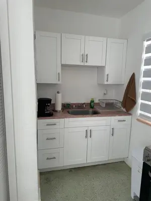 a kitchen with white cabinets and a sink at Villa Clara VIP-Little Havana in Miami