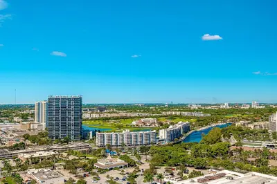 an aerial view of a city with a river and buildings at Modern Resort with Amazing Pool in Hallandale Beach