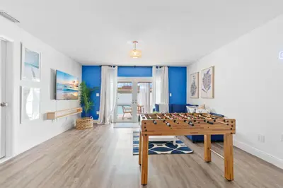 a living room with a foosball table and blue walls at Casa Santorini - Big Pool - Barbacoa - Fun and Relax in Miami