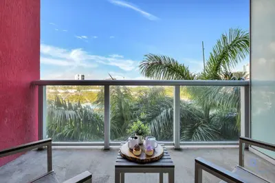 a table on a balcony with a view of trees at Great views Apartment with Pool-Balcony-Gym in Hallandale Beach