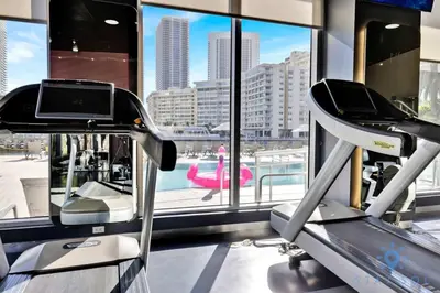 a gym with a view of a city at Top Luxury Apartment with Pool & Gym in Hallandale Beach