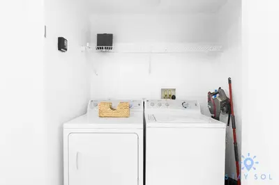 a white laundry room with a washer and dryer at Modern 2BR 2BA Oasis & pool in Hallandale Beach
