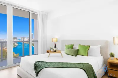 a bedroom with a large bed and a large window at Urban Apartment Balcony & Pool in Hallandale Beach