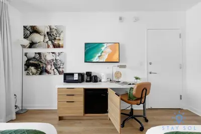 a room with a desk with a computer in it at Stylish Apartment Near Beach in Hallandale Beach