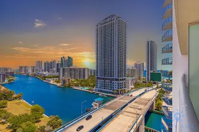 a view of a city with a river and buildings at Stylish Apartment Near Beach in Hallandale Beach