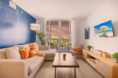a living room with a couch and a table at Modern Resort -Balcony Views & Pool in Hallandale Beach