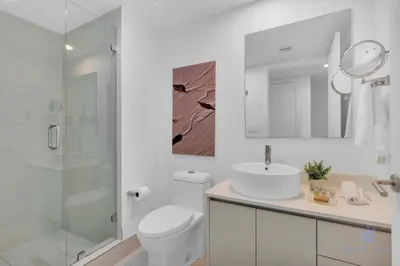 a bathroom with a toilet and a sink and a shower at Lovely Studio with Amazing View gym and amenities in Hallandale Beach