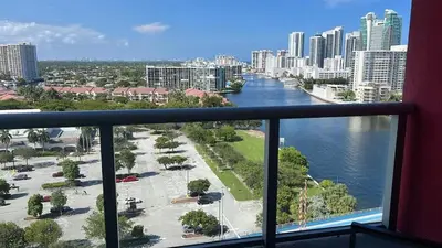 a balcony with a view of a river and a city at 2 Bed & 2 Bath at Beachwalk With Pool Gym on 16fl in Hallandale Beach