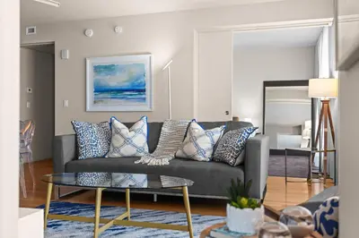 a living room with a couch and a table at 2BR W Resort, Birds eye view of it all, Professionally Designed in Fort Lauderdale