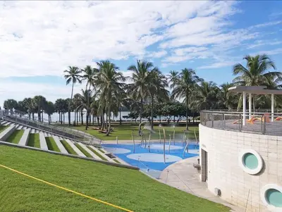 a park with palm trees and a fountain at Art Deco Suite Steps from Beach in South of Fifth in Miami Beach
