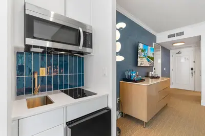 a kitchen with a sink and a microwave at Fontainebleau Hotel Junior Suite in Miami Beach