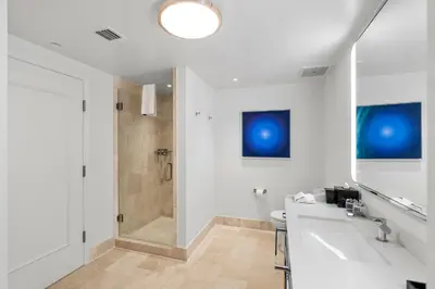 a bathroom with a sink and a shower at Fontainebleau Hotel Junior Suite in Miami Beach