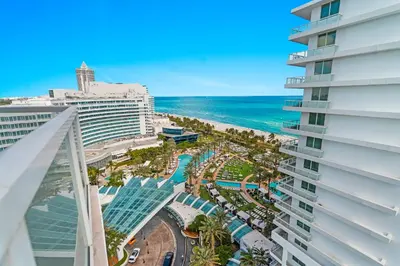 a view of the beach from the balcony of a building at Fontainebleau Hotel Junior Suite in Miami Beach