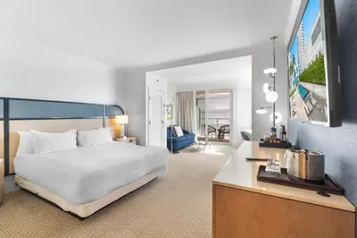 a bedroom with a bed and a living room at Fontainebleau Hotel Junior Suite in Miami Beach