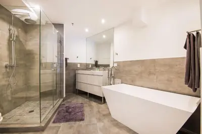 a bathroom with a large white tub and a shower at Luxury - Ocean front - Free Parking - 3 Bed 2 Bath in Miami Beach