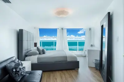 a bedroom with a bed and a view of the ocean at Luxury - Ocean front - Free Parking - 3 Bed 2 Bath in Miami Beach