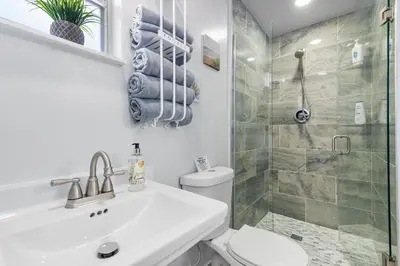 a bathroom with a sink and a toilet and a shower at Cozy Casarita Cottage in Miami