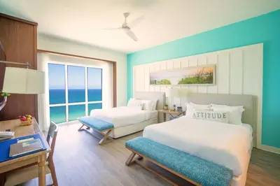 a hotel room with two beds and a window at Margaritaville Hollywood Beach Resort in Hollywood
