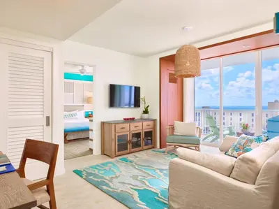 a living room with a couch and a tv at Margaritaville Hollywood Beach Resort in Hollywood