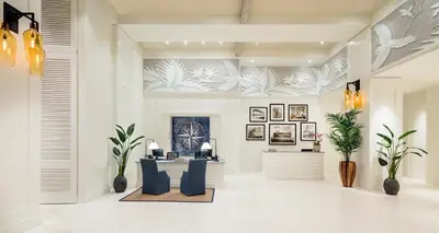 a lobby with blue chairs and a reception desk at Margaritaville Hollywood Beach Resort in Hollywood