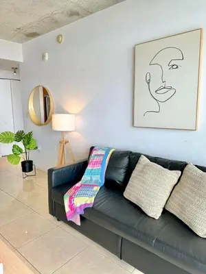 a black leather couch in a living room at Stylish and Spacious Condo Prefect to Enjoy Miami! in Miami