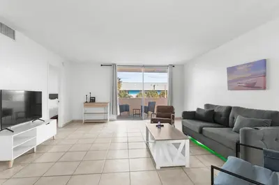 a living room with a couch and a tv at Bay Harbor Sunset 3A in Miami Beach