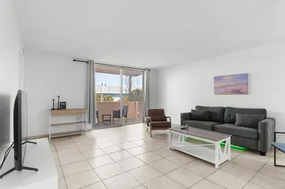 a living room with a couch and a tv at Bay Harbor Sunset 3A in Miami Beach