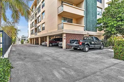 a truck parked in a parking lot in front of a building at Bay Harbor Sunset 3A in Miami Beach