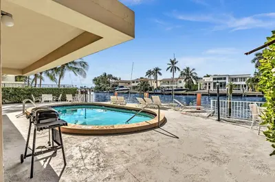 a swimming pool with a hot tub and a grill at Bay Harbor Sunset 3A in Miami Beach