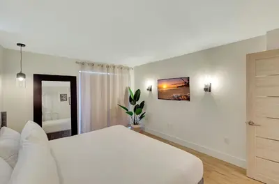 a white bedroom with a large white bed in it at Modern 2Bedroom in South Beach - Steps away from Lincoln Rd in Miami Beach