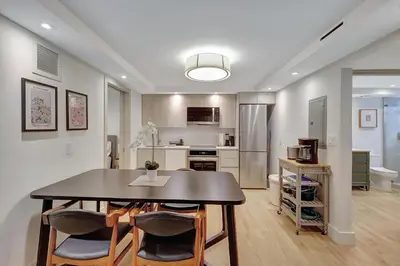 a kitchen and dining room with a table and chairs at Modern 2Bedroom in South Beach - Steps away from Lincoln Rd in Miami Beach
