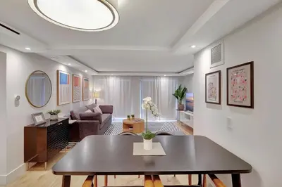 a living room with a table and a couch at Modern 2Bedroom in South Beach - Steps away from Lincoln Rd in Miami Beach