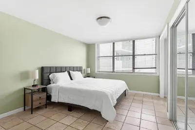 a bedroom with a bed and a window at Bay Harbor Sunset Apt 3B in Miami Beach
