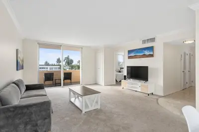 a living room with a couch and a tv at Bay Harbor Sunset Apt 3C in Miami Beach