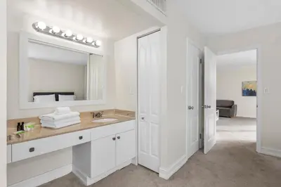 a white bathroom with a sink and a mirror at Bay Harbor Sunset Apt 3C in Miami Beach