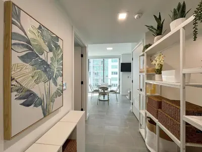 a hallway with a dining room with a table at 227-2212AM DOWNTOWN MIAMI STUDIO in Miami
